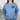Cavalier King Charles Spaniel light blue sweatshirt modeled by a woman standing in her living room with her hands in her pockets.