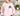 English Setter sweatshirt in light pink modeled by a woman sitting on a couch in her living room.