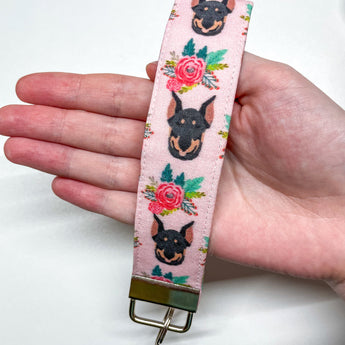 Light pink Doberman Pinscher and flower key fob with silver metal hardware.