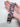 Hand holding a floral Golden Retriever print fabric key fob to show scale and pattern.