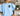 Irish Water Spaniel light blue sweatshirt modeled by a woman sitting on a couch in a living room.