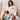 White long haired Dachshund sweatshirt modeled by a woman sitting on a couch with a long haired dachshund in her lap.