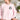 English Toy Spaniel light pink sweatshirt modeled by a woman sitting on a cream couch in a living room.