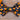 A black dog bow tie with orange and white candy corn patterns.