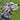 A dog wearing a pink and black striped flower snood.